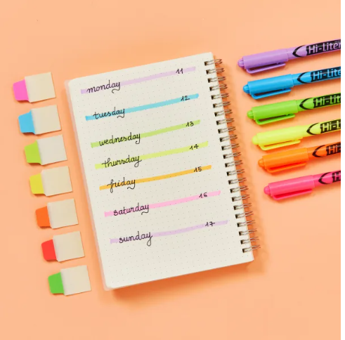 A color-coded weekly schedule organized with Avery 74762 and 74763 neon mini Ultra Tabs, paired with matching Hi-Liters in vibrant shades. Each day of the week is written in neat handwriting with corresponding highlighter accents, creating a cohesive and visually appealing layout. The bright Ultra Tabs are arranged to the side, offering a functional and creative planner idea for managing tasks and staying organized with ease.