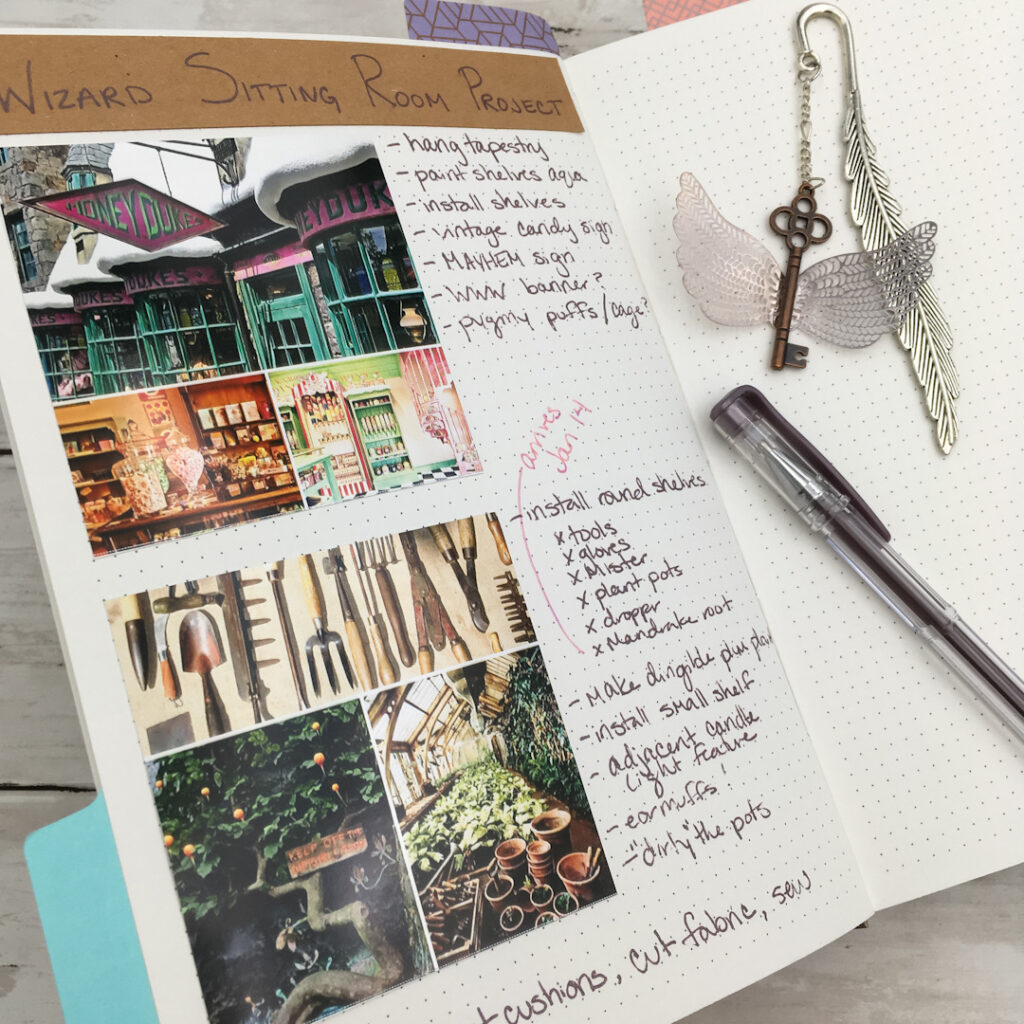 A bullet journal spread titled "Wizard Sitting Room Project" features a creative mix of photos, handwritten notes, and to-do lists glued on the page. The page includes images of themed decor, tools, and a greenhouse, paired with neatly written tasks such as "paint shelves" and "install round shelves." A decorative bookmark with a key and feather charm adds a whimsical touch, while a purple pen rests nearby for additional notes. The spread captures the process of planning and organizing a magical-inspired room design.